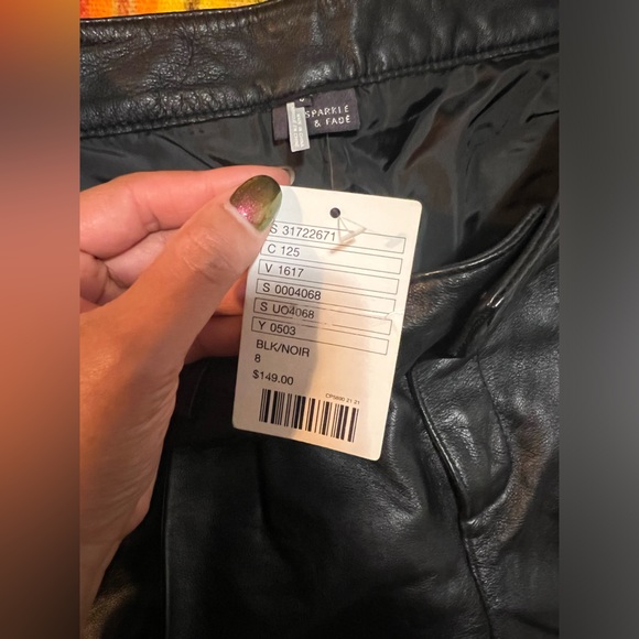 Genuine leather black mini shorts lined with silver metal grommets. Size 8 - Picture 6 of 7